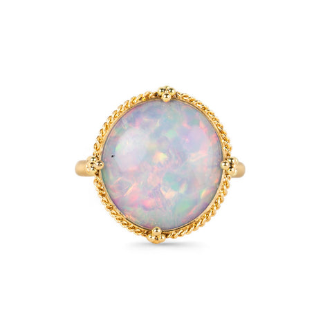 Gold ring with an opal stone on a white background