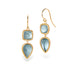 Gold earrings with blue aquamarine gemstones on a white background