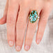 hand wearing a turquoise ring with gold bezel and sterling silver band 