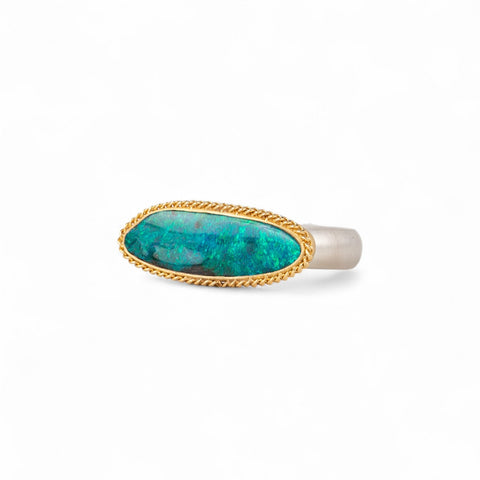 Boulder opal ring with an 18k gold bezel and sterling silver band