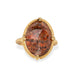 Gold ring featuring a sunstone gemstone on a white background