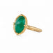 Gold ring with an emerald gemstone on a white background
