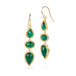 Gold earrings with emerald gemstones on a white background
