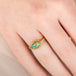 Gold ring with an Ethiopian opal stone on a hand