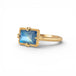 Gold ring with a blue moonstone on a white background