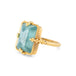 Gold ring with a large aquamarine gemstone on a white background