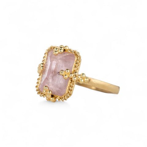 Gold ring with a morganite stone on a white background