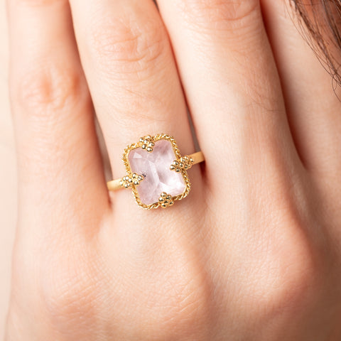 Gold ring with a morganite stone on a person's finger