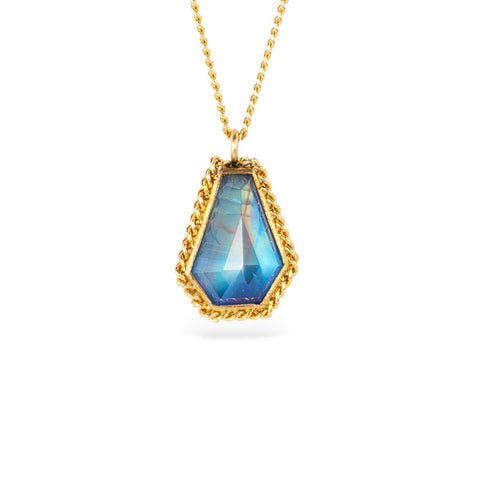Gold necklace with a moonstone pendant on a white background
