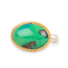 A gold and silver ring featuring an oval gem silica stone on a plain white background.