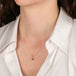 Gold necklace with brown diamond stone on a person