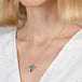 Gold mushroom necklace with a tourmaline and boulder opal stone on a person