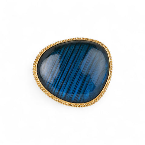 Front surface of a ring with labradorite stone set in a gold  bezel with a silver band
