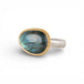 Ring with a gold bezel, silver band and labradorite stone on a white background