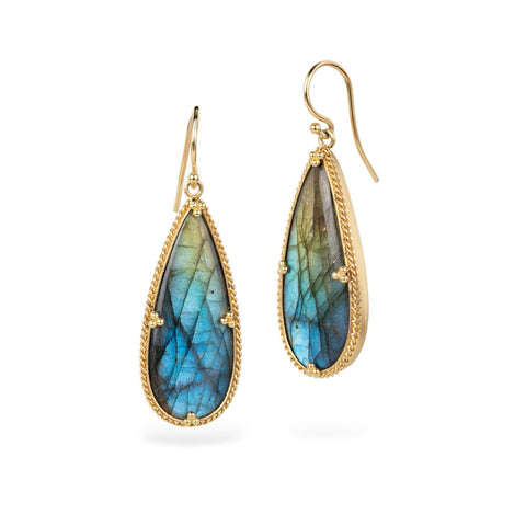 Teardrop-shaped labradorite earrings with gold frames on a white background