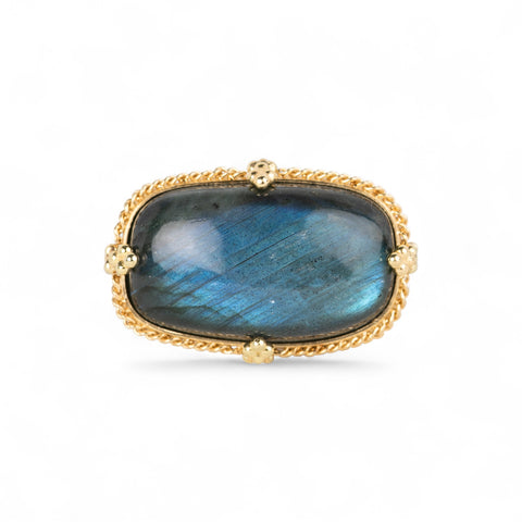 Gold ring with a labradorite gemstone on a white background