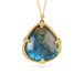 Necklace with a labradorite gemstone and gold frame on a white background