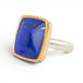 Ring with lapis stone, gold setting and silver band on a white background