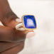 Gold and silver ring with a lapis stone held in hand