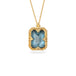 A gold necklace featuring a london blue topaz stone set in an 18k gold bezel, against a white background