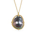 Mabe pearl pendant necklace with gold setting on a white background