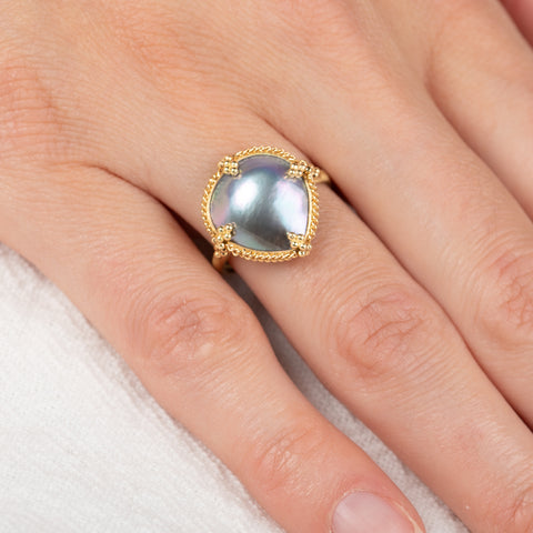 Gold ring with a mabe pearl on a hand