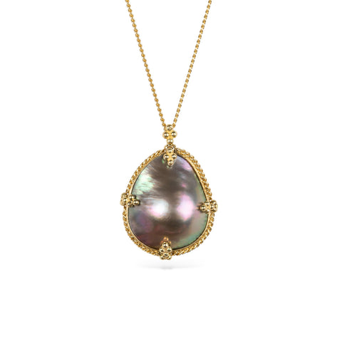 Gold necklace with a mabe pearl pendant on a white background