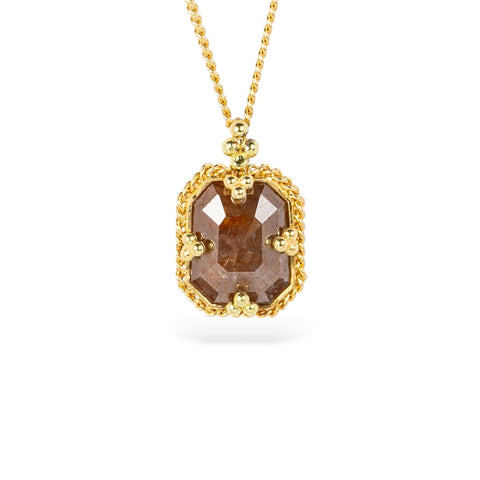 Gold necklace with a brown diamond gemstone pendant on a white background