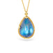 Blue moonstone teardrop pendant with gold frame on a white background