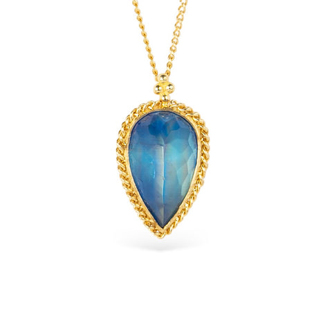 Gold necklace with a blue moonstone teardrop pendant on a white background