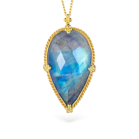 Gold necklace with a large teardrop moonstone pendant on a white background