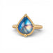 Gold ring with a blue teardrop-shaped moonstone on a white background
