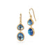 Gold earrings with moonstones on a white background