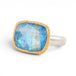 Gold and silver ring with a moonstone on a white background