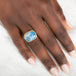 Gold and silver ring with a moonstone on a person's hand