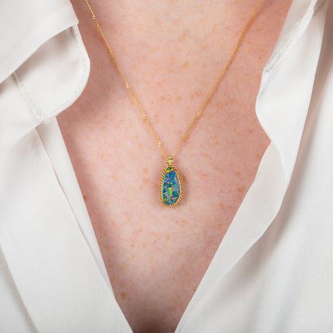 Handcrafted Australian opal and gold necklace on a person