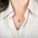 Handcrafted Australian opal and gold necklace on a person