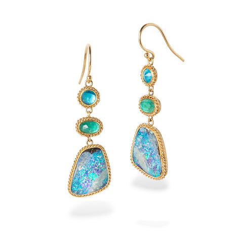 Gold earrings with apatite, emerald and boulder opal gemstones on a white background