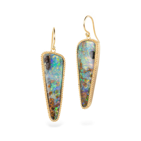 Boulder opal earrings with gold settings on a white background