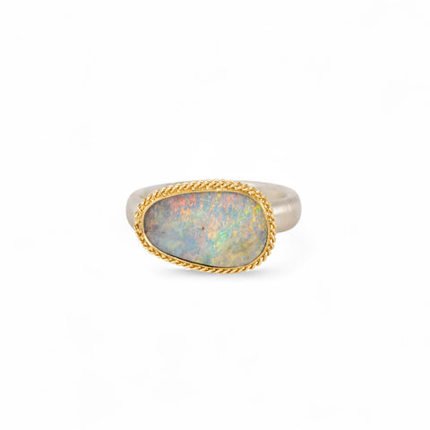 Handmade fine jewelry boulder opal ring with an 18k gold bezel and sterling silver band