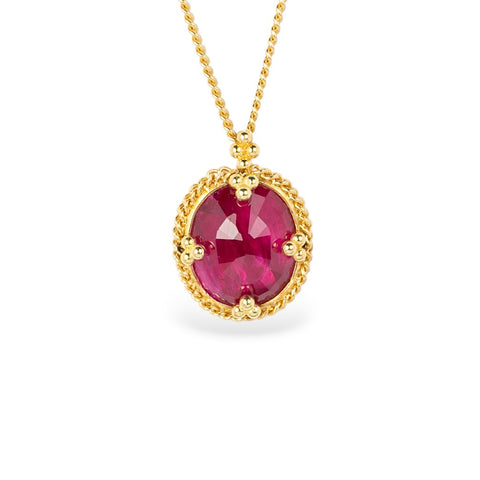 Gold necklace with an oval ruby gemstone pendant on a white background
