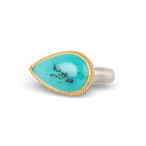 Handmade ring with peruvian opal stone on a white background