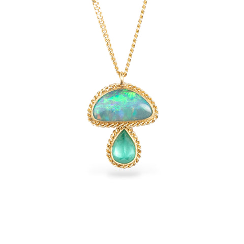 Gold necklace with a mushroom pendant on a white backgorund