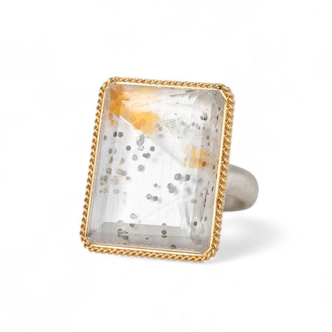 Handmade fine jewelry ring featuring a pyrite in quartz gemstone with an 18k gold bezel and sterling silver band