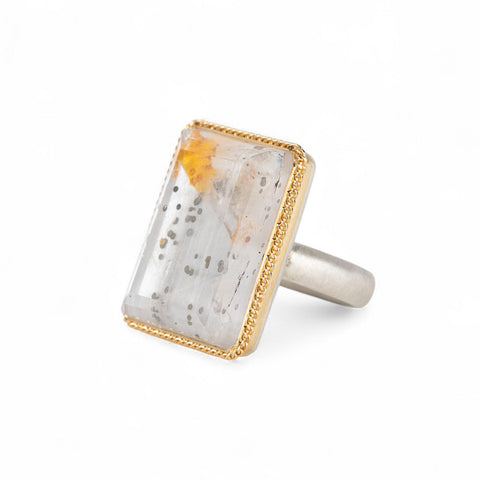 Handmade fine jewelry ring featuring a pyrite in quartz gemstone with an 18k gold bezel and sterling silver band