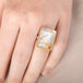 Handmade fine jewelry ring featuring a pyrite in quartz gemstone with an 18k gold bezel and sterling silver band