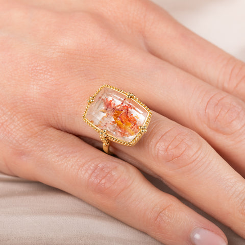 Gold ring with a Quartz with Pyrite on a person's finger