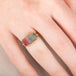 Handcrafted gold ring with a watermelon tourmaline gemstone worn on a hand