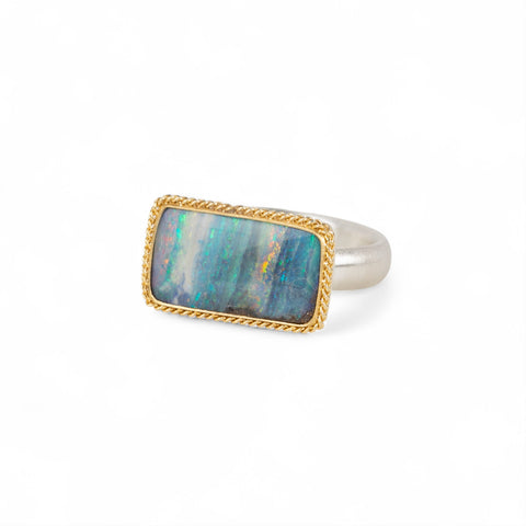Handmade fine jewelry boulder opal ring with an 18k gold bezel and sterling silver band
