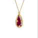 Gold necklace featuring a ruby gemstone on a white background